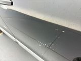 a close up of a car door handle with a sticker on it