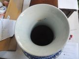 a blue and white vase sitting on top of a table