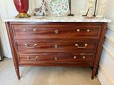 a dresser with a marble top in a room