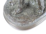 a statue of a dog that is standing on a base