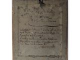 an old book with writing on it sitting on top of a table