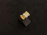 a close up of a gold and diamond ring on a black surface