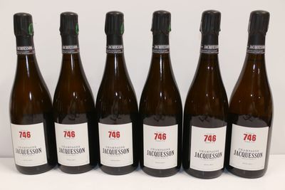 six bottles of wine are lined up in a row on a table