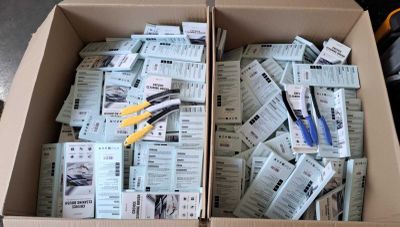 a box full of tickets and scissors sitting on the floor