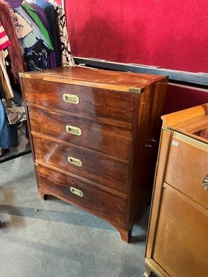 a dresser and a chest of drawers in a room