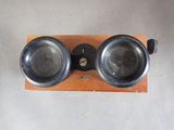 an old pair of goggles sitting on top of a wooden stand