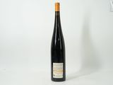 a bottle of wine sitting on top of a white table