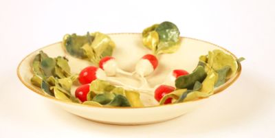 a bowl of salad with broccoli and tomatoes in it