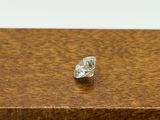 an image of a diamond on a wooden table