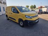 the yellow van is parked in a parking lot near a building