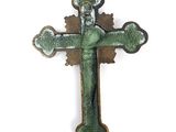 a green cross with a crown on it on a white background