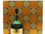 the bottle of liquor is sitting next to a box on the table