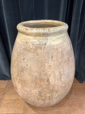 a large stone pot sitting on a wooden table