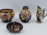 three vases and a bowl are sitting next to each other