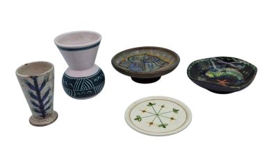 many different types of vases and plates on the table