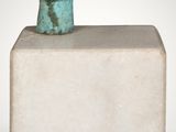 an image of a sculpture of a head sitting on top of a block
