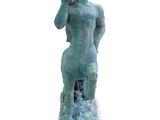 statue of a man on a rock holding a cell phone to his ear