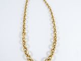 a gold chain necklace on a white background