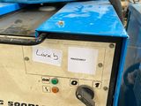 a blue machine that is sitting in a warehouse