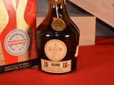 a bottle of liquor sitting next to a box on a table