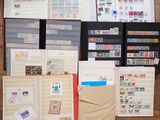 many different types of stamps and envelopes laid out on the floor
