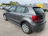 the back end of a gray volkswagen polo parked in a parking lot