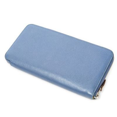 the blue leather wallet is open on a white surface