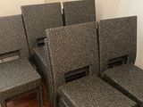 four chairs and a table in a room with wood flooring