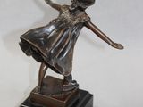 bronze statue of a young girl dancing on a black base