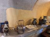 a picture of a kitchen counter with pots and tea kettles