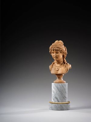 a carved bust of a woman on a marble pedestal
