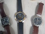 several different types of watches are displayed on a table