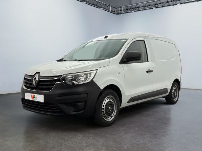 La camionnette blanche est garée dans une grande pièce.