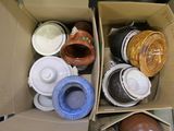 many cups and saucers in a box on the floor