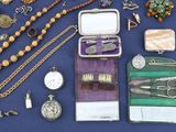 many different types of jewelry on a blue table