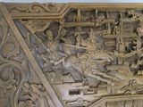 a wooden carving of a man on a horse and a man on a horse