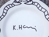 a white plate with a drawing of a snake on it