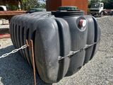 a large black tank sitting on the ground with a chain around it