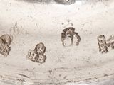 a close up of a silver plate with numbers on it