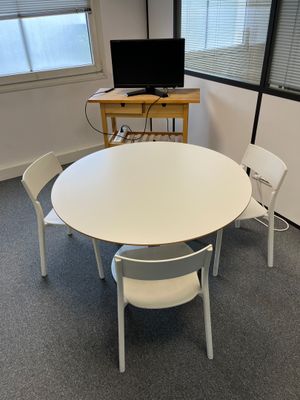 a white table and chairs in the corner of a room