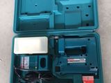 a blue tool box with tools inside of it on the floor