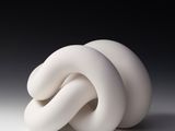 a white sculpture of a knot on a white surface