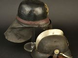 two helmets are sitting on a black surface next to each other