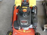 a lawn mower that is sitting in the garage