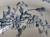 a blue and white plate with a flower design on it