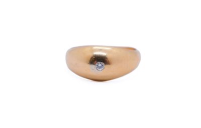 a close up of a gold ring with a diamond on it