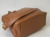 a brown leather bag on a white background