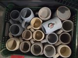 a lot of cups in a green basket on the floor