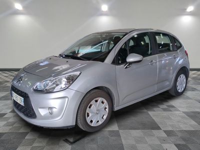 a picture of a silver car parked in a garage