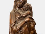 a statue of a woman holding a child in her arms